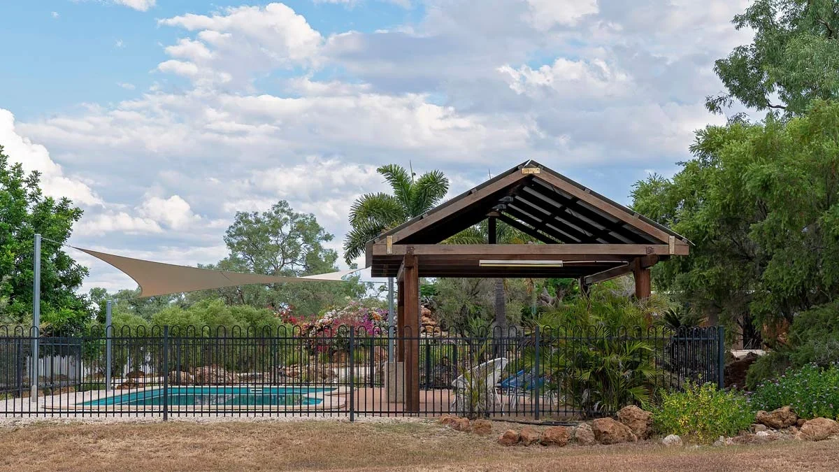 Aluminium pool fence enclosing a backyard pool area