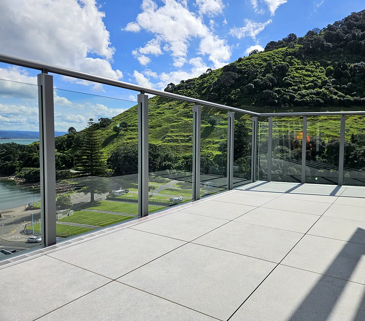 Glass balustrade on a Mount Maunganui apartment terrace with views of Mauao